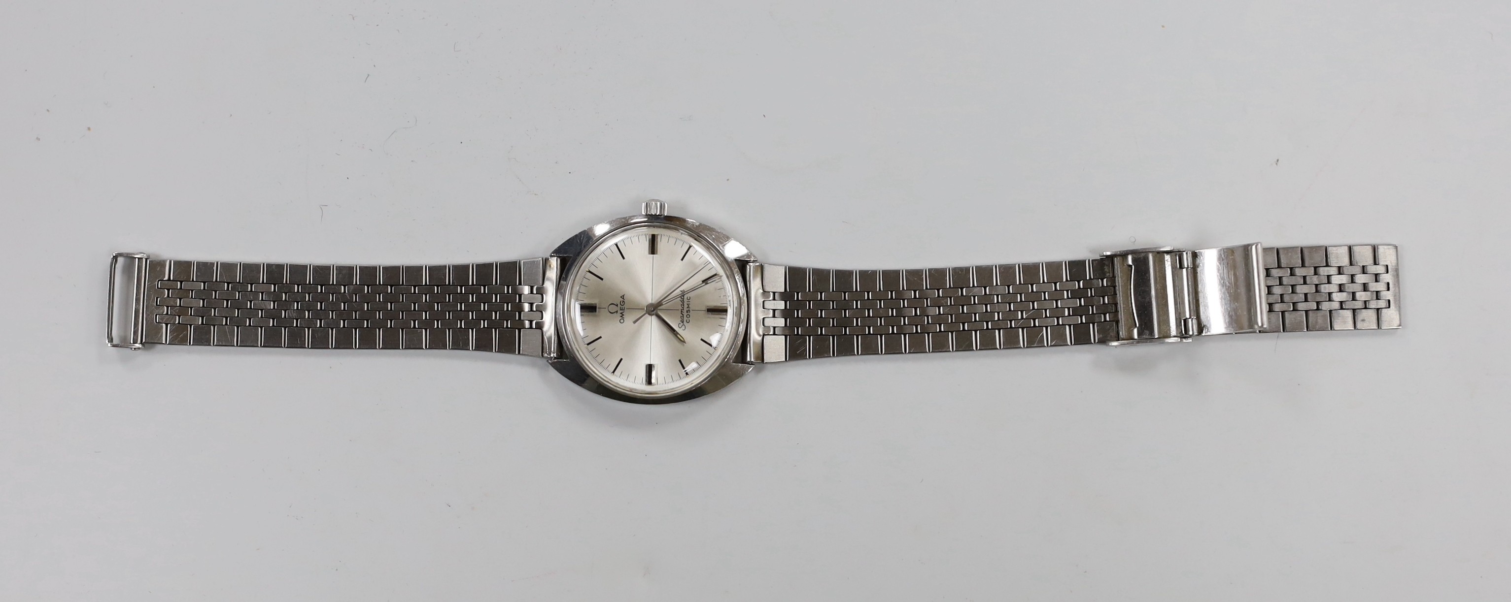 A gentleman's 1970's? stainless steel Omega Seamaster Cosmic manual wind wrist watch, on associated bracelet, case diameter 34mm.